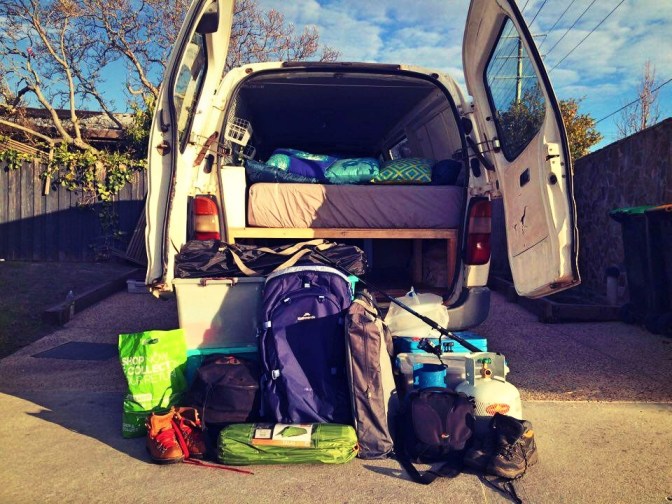 Rear view of campervan with unpacked belongings