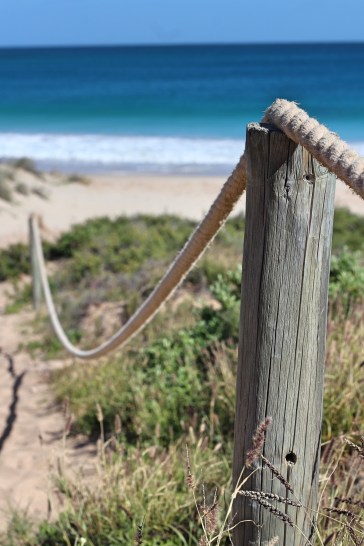 Wooden rope fence Red Bluff beach Western Australia